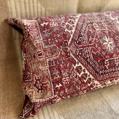 a red and white pillow sitting on top of a couch