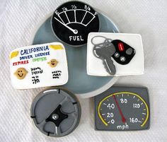 a plate that has some cookies on top of it with car keys and fuel gauges