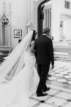 a bride and groom walking down the aisle at their wedding ceremony in black and white