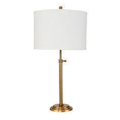 a gold lamp with a white shade on it