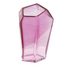 a pink glass vase sitting on top of a white table