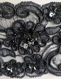 an image of black lace with flowers on it