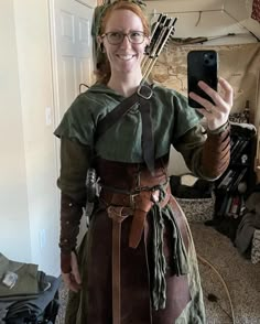 a woman dressed in an old fashioned outfit taking a selfie