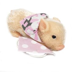 a small stuffed animal with a pink and white hat on it's head,