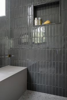 a bath room with a tub and a shelf