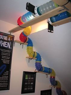 there are many items on the shelf above the water bottle rack in this room,