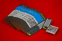 a pile of cards with qr code on them sitting next to each other in front of a red background