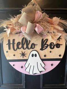 a wooden sign that says hello boo with a ghost in the center and stars around it