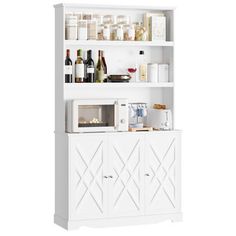 a white kitchen cabinet filled with lots of food and drink bottles on top of it