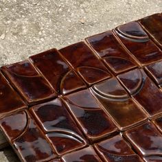 a close up view of some brown tiles on the ground