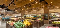 a grocery store filled with lots of fresh fruits and veggies in bins