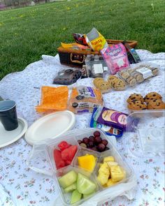 a picnic table with food and drinks on it