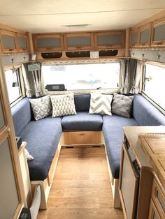 the inside of an rv with couches and cabinets