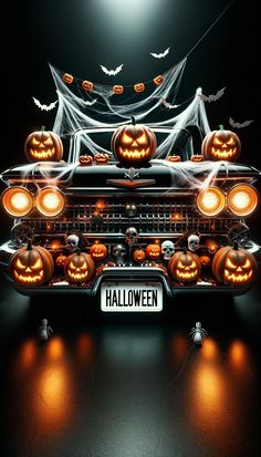 an old car decorated with pumpkins and ghost's is shown in the dark