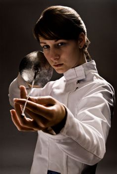 a woman holding a spoon in her right hand