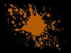 an orange paint splattered on a black background