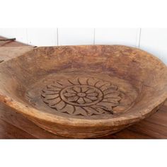 a wooden bowl sitting on top of a table