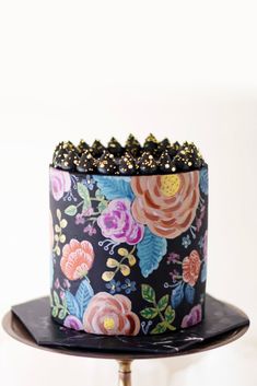 a decorated cake sitting on top of a black plate