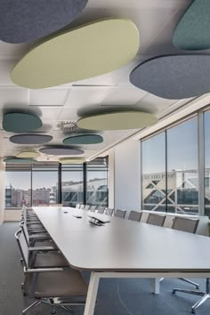 an empty conference room with large windows overlooking the city