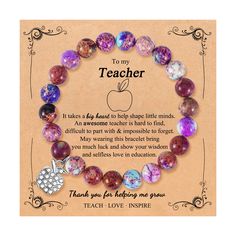 the teacher bracelet with an apple charm on it is shown in front of a card