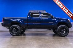 a large blue truck parked in a garage