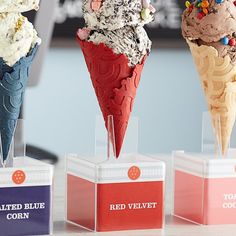 three different flavors of ice cream on display in front of an advertisement for red velvet