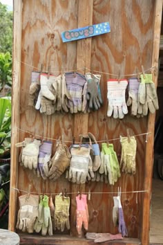 several pairs of gloves hanging on a clothes line