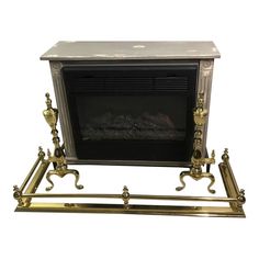 an antique fireplace with gold accents and a black fire place next to it on a white background