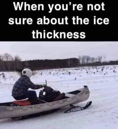 a man riding on the back of a snowmobile