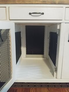 the inside of a white cabinet with black mesh doors