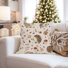 a living room with a christmas tree in the background and a hedge pillow on the couch