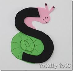 the letter s is made out of paper and has a snail on it's back