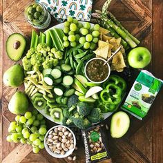 an assortment of fruits and vegetables are arranged on a platter, including broccoli