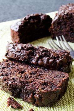 there is a piece of chocolate cake next to a fork on a napkin with a bite taken out of it