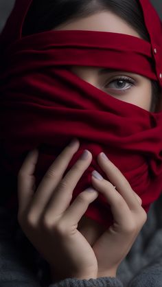 a woman wearing a red scarf covering her face