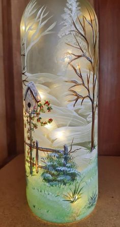 a glass jar with a painting on it