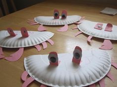 several paper plates with food on them sitting on a wooden table, covered in pink tape