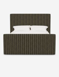 an upholstered bed with white pillows and striped headboard, made from fabric