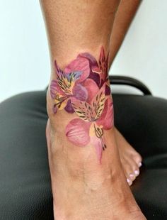 a woman's foot with flowers painted on it