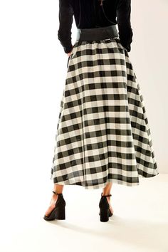 The Deanna skirt is back, now in a chic black and white check! This A-line maxi-length skirt is perfect for the holiday season. The removable black sash adds a stylish pop to this already fabulous piece. Pair it with an elegant velvet top and black heels for a classy look! A-line Maxi skirt Pleats at waist Elastic at back waist Removable sash at waist Made in USA SC 524-118 Taffeta Skirt, Velvet Top, Velvet Tops, How To Look Classy, Handbags On Sale, Black Heels, Pleated Skirt, Vest Jacket, Scarf Wrap