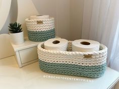 two white and blue baskets sitting on top of a counter