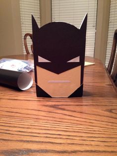 a batman mask sitting on top of a wooden table