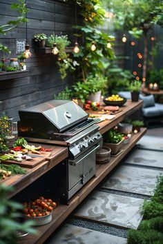 an outdoor bbq surrounded by greenery and potted plants with lights hanging from the ceiling