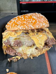 a cheeseburger is being held up to the camera