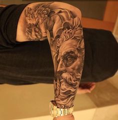 a man's arm with tattoos on it and an image of a bearded man