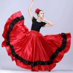 a woman in a red and black dress is dancing