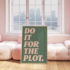 a sign that says do it for the plot in front of a couch and window