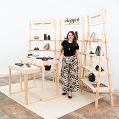 a woman standing in front of a display of shoes