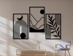 three black and white art pieces hanging on the wall above a dining room table with chairs