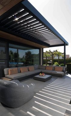 an outdoor living area with couches and tables